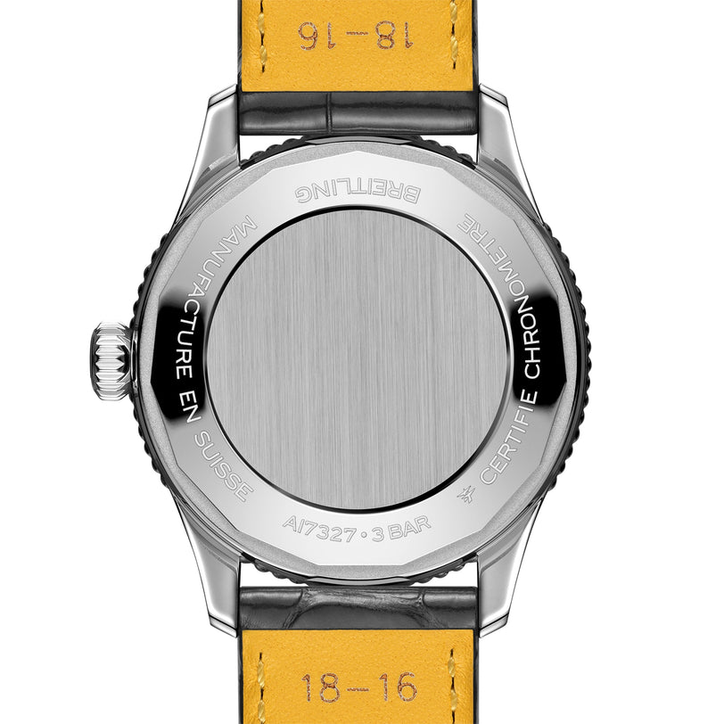 The back of a Breitling Navitimer Automatic 36 watch features a metal case with engraved markings, a black crown, and a yellow leather strap with visible stitching and size markings.