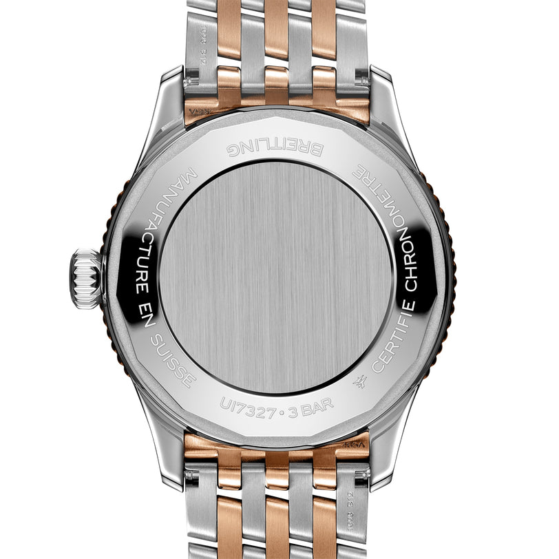 Close-up of the back of the Breitling Navitimer Automatic 36, highlighting its stainless steel and rose gold bracelet with detailed engravings on the chronograph caseback.