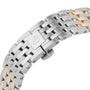 Close-up of the Navitimer Automatic 36’s metal bracelet with alternating silver and gold links and a clasp engraved with Breitling’s stylized B, reflecting the classic elegance of this iconic timepiece.