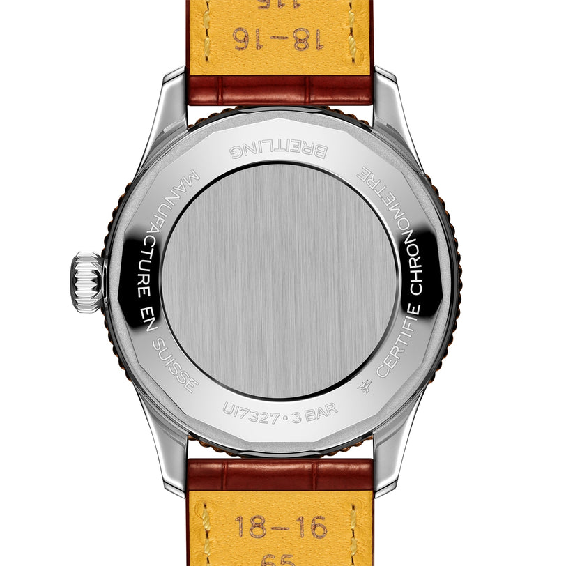 Back view of the Breitling Navitimer Automatic 36 wristwatch with a brown leather strap, displaying its stainless steel case back and engraved model details.