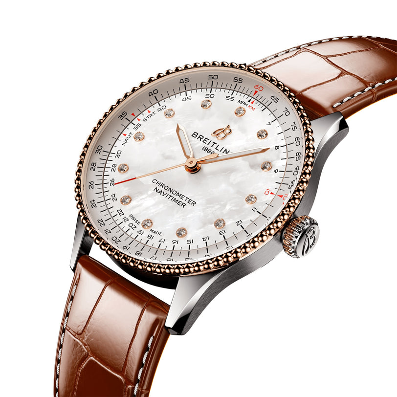 The Breitling Navitimer Automatic 36 features a white mother-of-pearl dial with diamond markers, a brown leather strap, and a stainless steel case—blending classic style and precision in an elegant wristwatch.