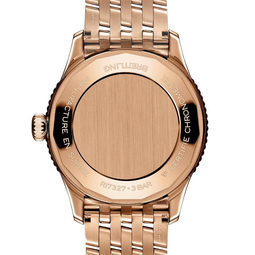 Back view of the Breitling Navitimer Automatic 36 in rose gold, showcasing its engraved metal case back and elegant linked bracelet.