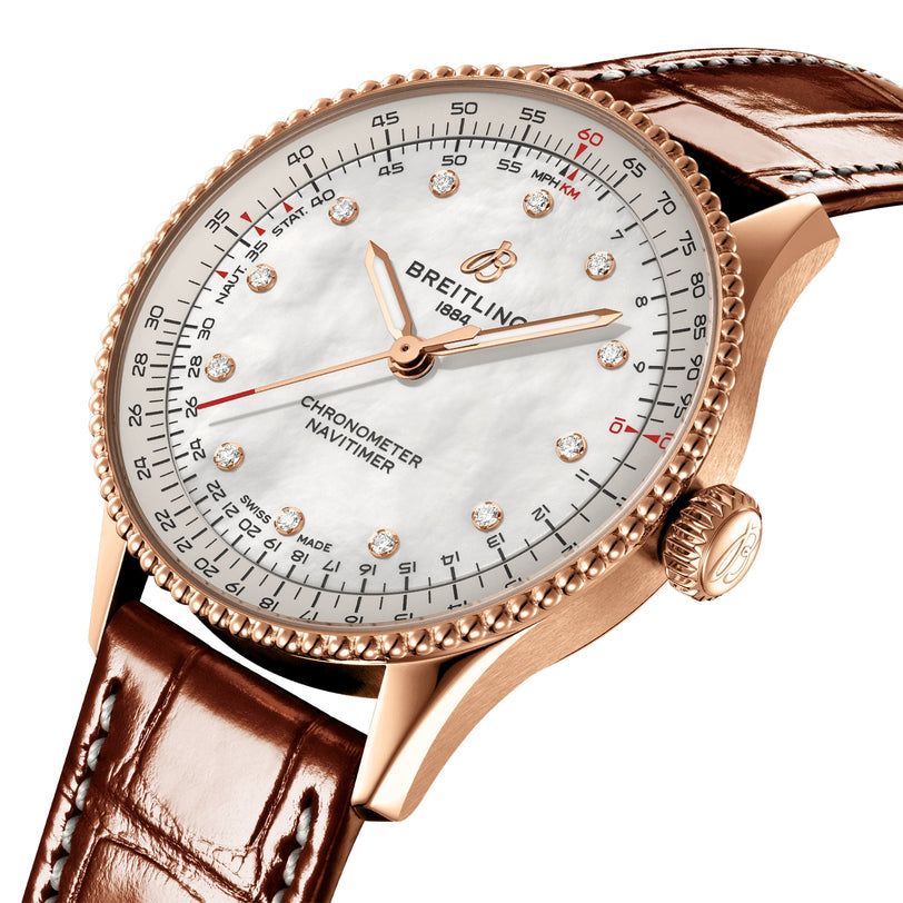 The Breitling Navitimer Automatic 36 features a rose gold case, white dial with diamond hour markers, brown leather strap, and is powered by the reliable Breitling 17 calibre movement.