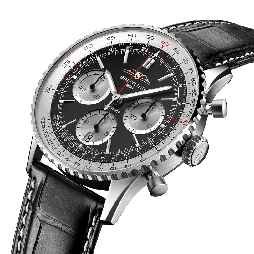 Close-up of the Breitling Navitimer B01 Chronograph 41, showing its black dial with three subdials, silver bezel, and a black leather strap with white stitching.