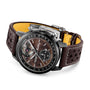 The Breitling Top Time B21 Chevrolet Corvette is a luxury watch featuring a brown leather strap, black bezel, visible tourbillon, racing chronograph features, and a wood-textured dial inspired by classic sports cars.