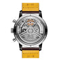 Back view of the Breitling Top Time B21 Chevrolet Corvette showing its exposed mechanical movement, labeled parts, and a yellow leather strap marked 22-18—capturing the classic sports car spirit.