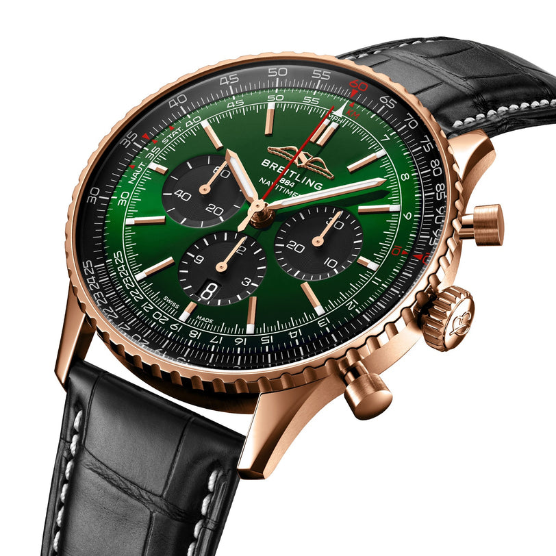 A Breitling Navitimer B01 Chronograph 46 with a green dial, gold case, black subdials, and a black leather strap with white stitching, shown against a white background.