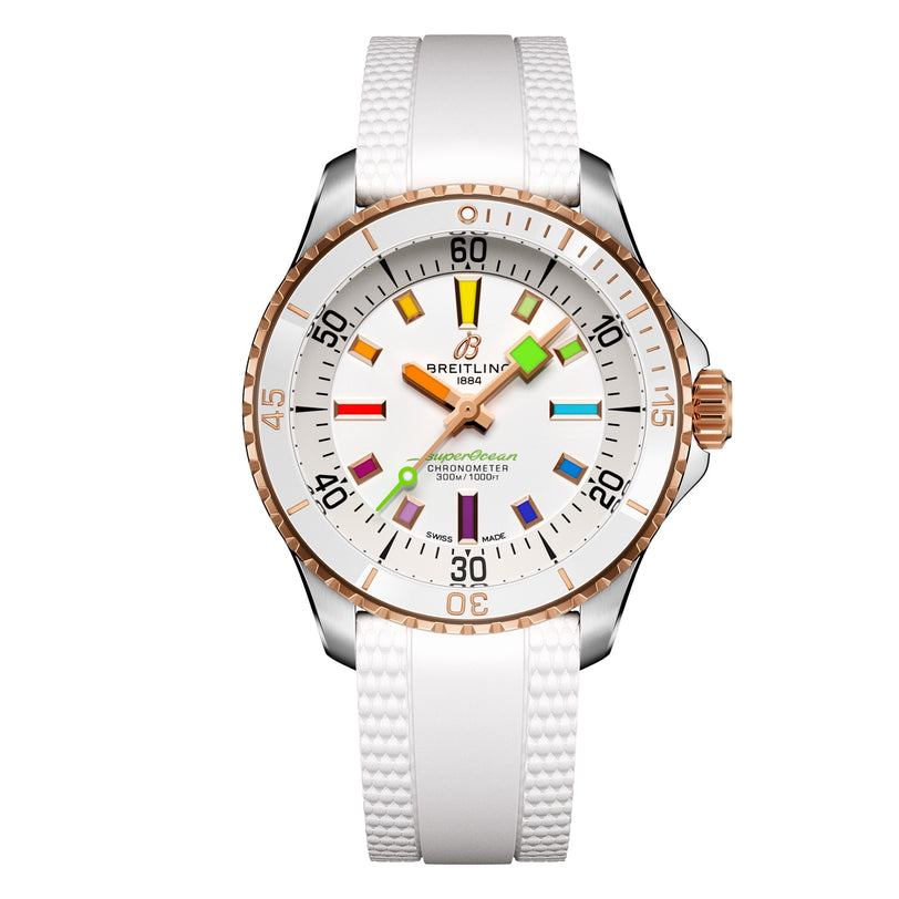 The Breitling Superocean Automatic 36 features a 36mm stainless steel case, white dial and strap, rose gold accents, and multicolored geometric hour markers.