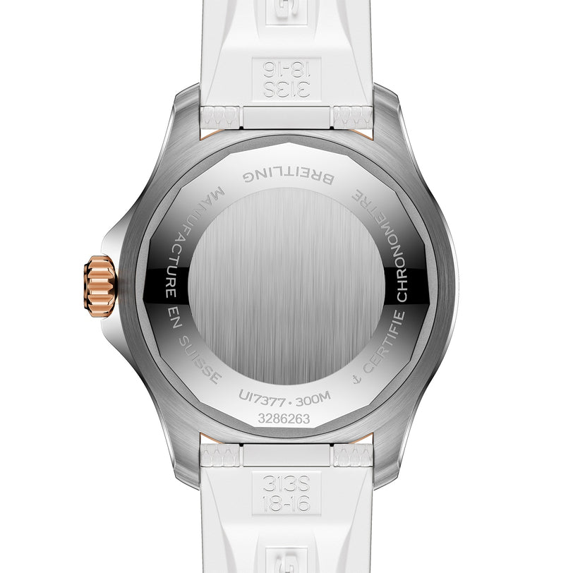 Back view of the Breitling Superocean Automatic 36, featuring a brushed stainless steel caseback with engraved specifications and serial numbers, completed by white straps.