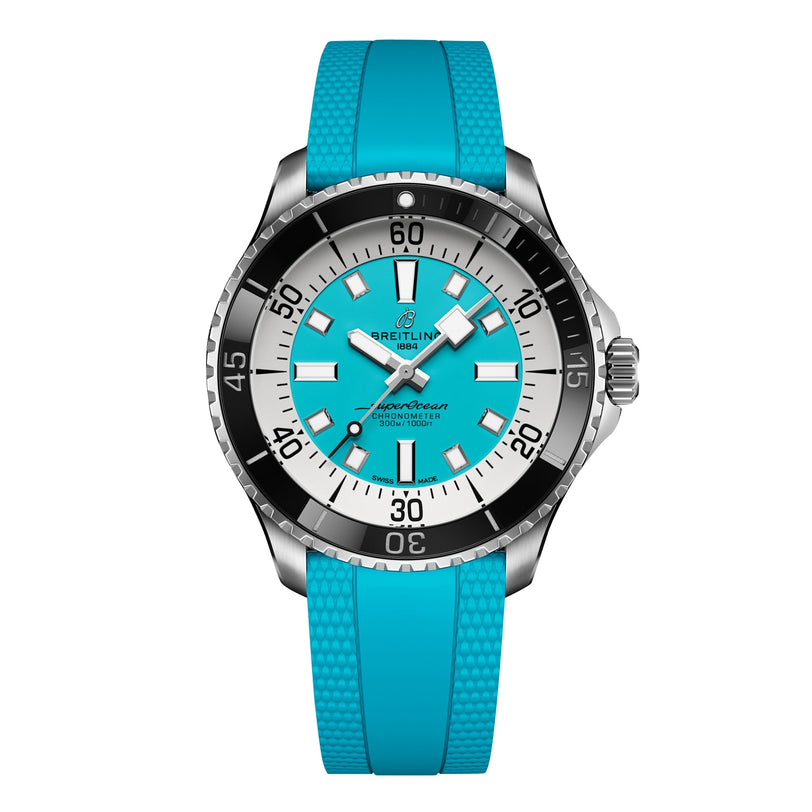 The Breitling Superocean Automatic 44 features a turquoise rubber strap and dial, silver case, black and silver bezel, bold white hour markers, and remarkable water resistance.