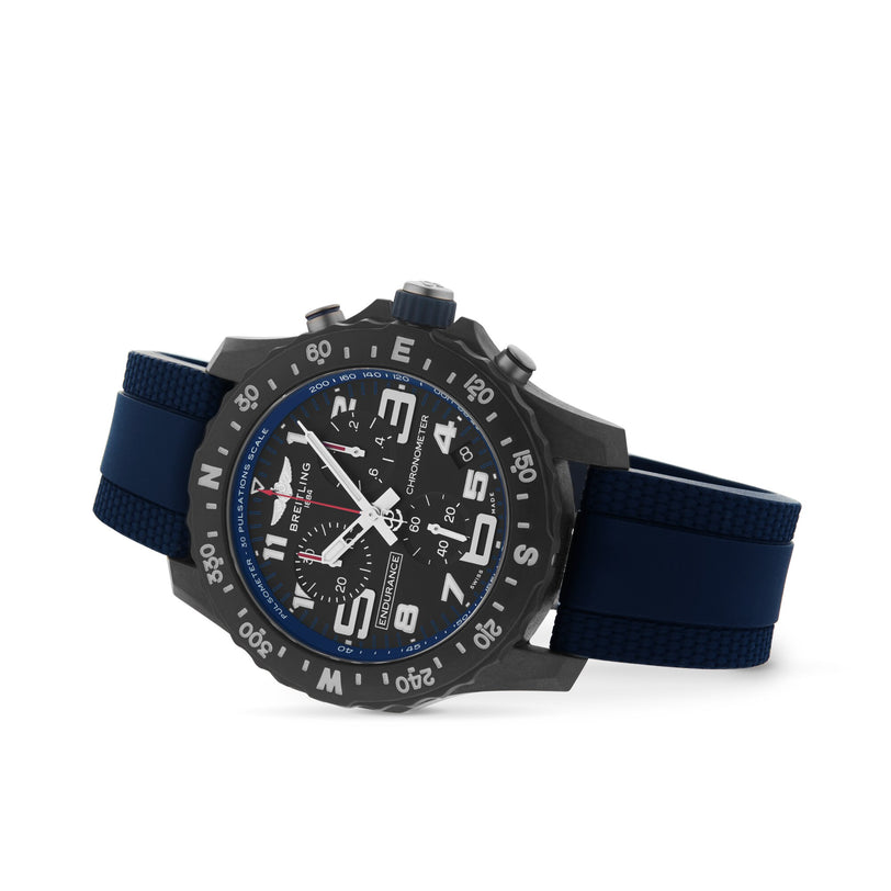A black and blue Breitling Endurance Pro 38 watch with a chronograph dial, large numerals, and a dark blue rubber strap is photographed against a white background.