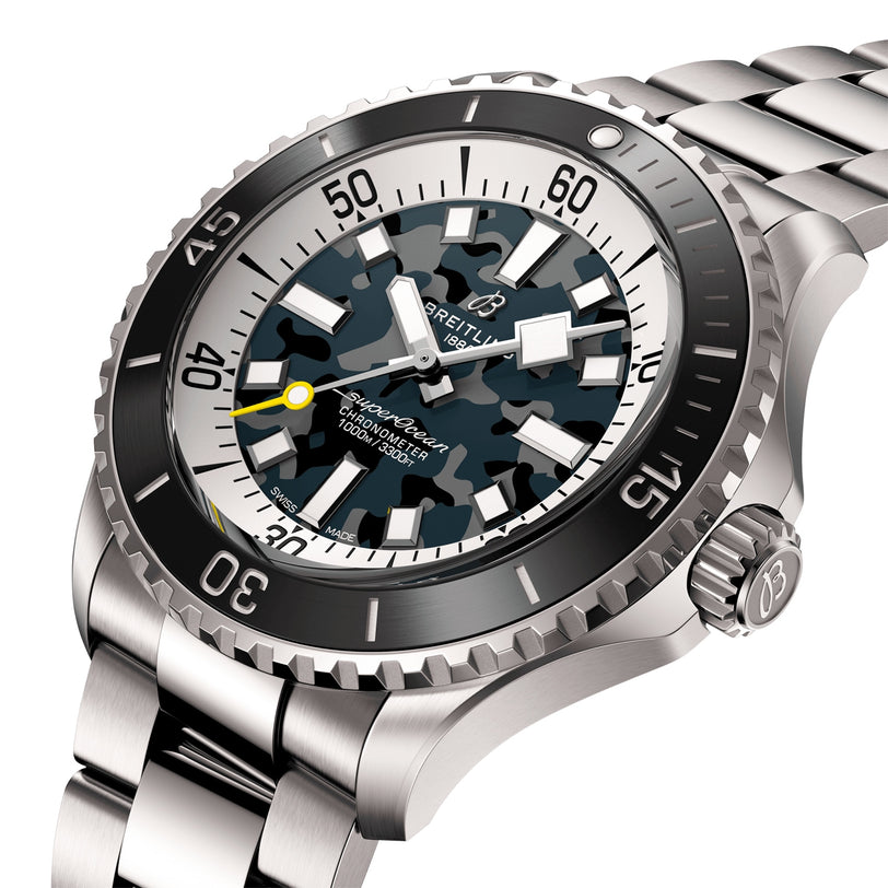 The Breitling Superocean Automatic 46 Super Diver features stainless steel, a camouflage-patterned dial, black bezel, silver hour markers, a metal link bracelet, and is powered by the Breitling 10 calibre movement.