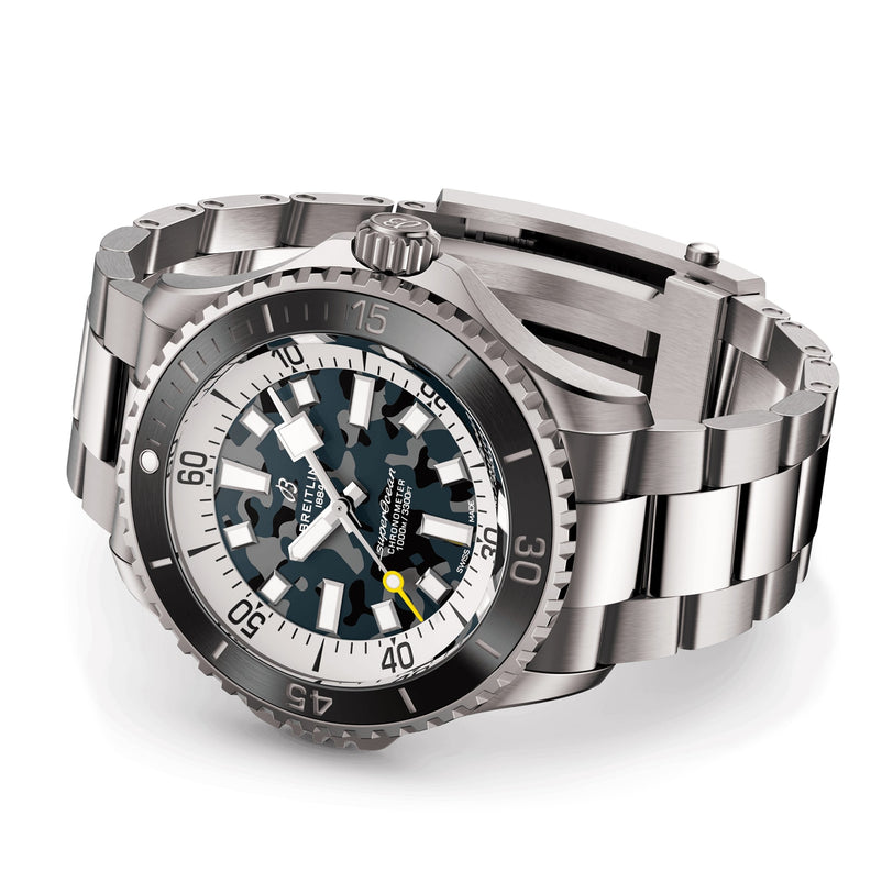 The Breitling Superocean Automatic 46 Super Diver, featuring a stainless steel and titanium case, black and gray camouflage dial, rotating bezel, and metal link bracelet, is displayed against a white background.