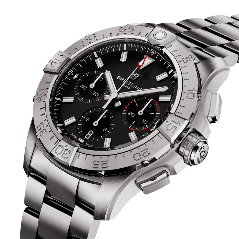 The Breitling Avenger B01 Chronograph 42 is a stainless steel wristwatch with a black dial, three subdials, aviation-style design, and metal link bracelet, shown at an angle.