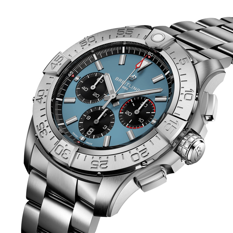 The Breitling Super Avenger B01 Chronograph 46 features a stainless steel case, blue dial with three subdials, date display, and rotating bezel on a metal bracelet—delivering bold aviation-inspired style.