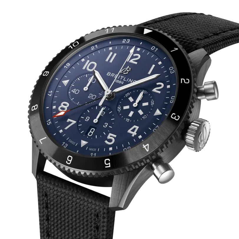 The Breitling Super AVI B04 Chronograph GMT 46 Tribute To Vought F4U is a black pilot’s watch with a blue dial, three sub-dials, white numerals, and a black textured strap, inspired by the legendary Vought F4U Corsair aircraft.