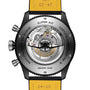 Back view of the Breitling Super AVI B04 Chronograph GMT 46 Tribute To Vought F4U, showing its exposed mechanical movement and yellow leather strap.