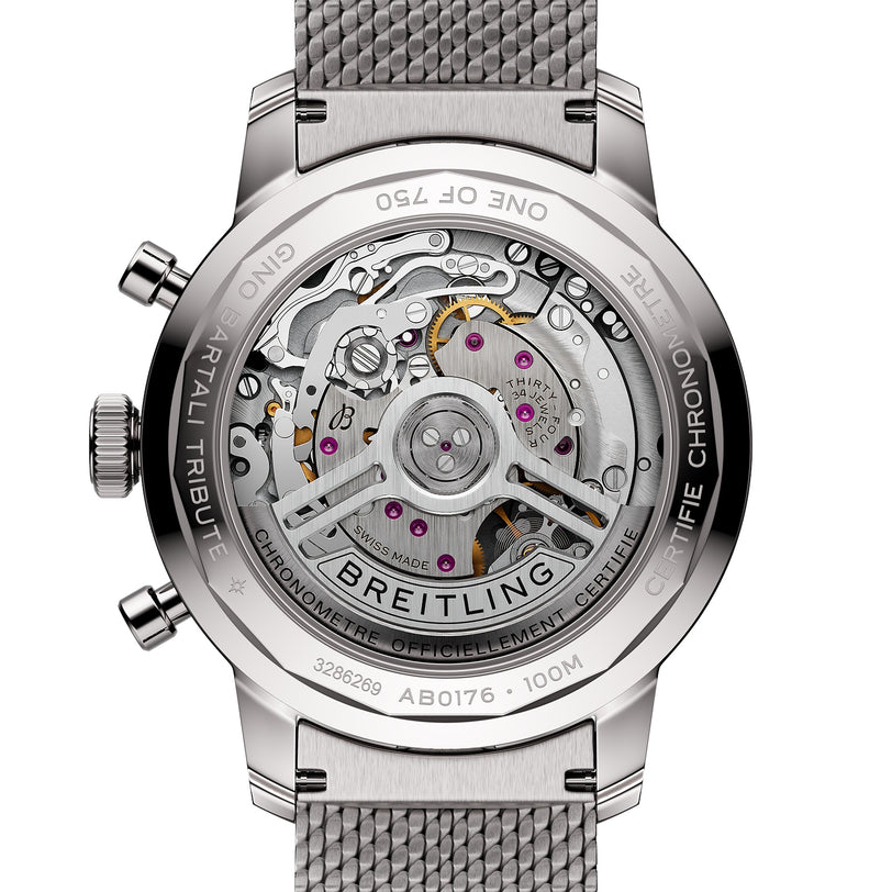 Close-up of the transparent case back of the Breitling Top Time B01 Gino Bartali watch, revealing its intricate mechanical movements, labeled components, and a metal mesh strap.