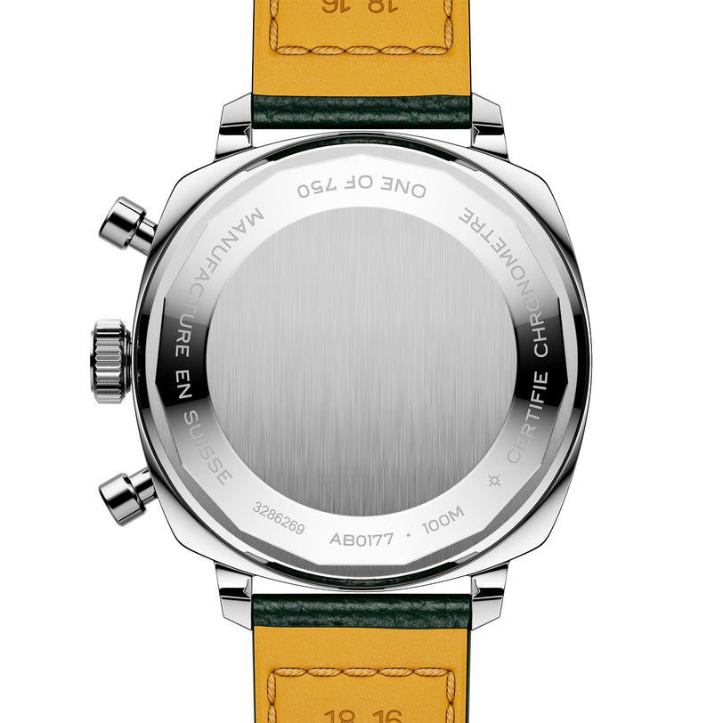 The image shows the back of the Breitling Top Time B01 Racing, a stainless steel wristwatch with a leather strap, engraved markings and serial numbers, highlighting its racing-inspired chronographs and modern-retro design.