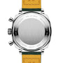 The image shows the back of the Breitling Top Time B01 Racing, a stainless steel wristwatch with a leather strap, engraved markings and serial numbers, highlighting its racing-inspired chronographs and modern-retro design.
