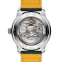 Back view of the Breitling Top Time B31 reveals its retro style, exposed Manufacture B31 movement, engraved metal case, and a yellow leather strap with green edges.