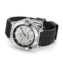 The Breitling Chronomat Automatic GMT Erling Haaland, featuring a silver case, black rubber strap, and textured dial, rests on its side.