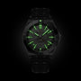 The Breitling Chronomat Automatic GMT Erling Haaland features green glowing hands and hour markers, showcased on a dark background.