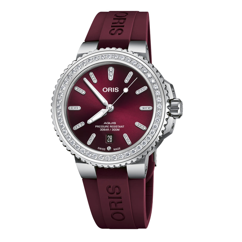 The Oris Aquis Date Diamonds wristwatch features a maroon dial, lab-grown diamond-set bezel, date display at 6 o’clock, and a matching maroon rubber strap.