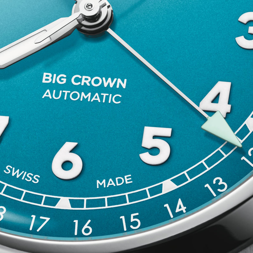 Close-up of the Oris Big Crown Pointer Dates turquoise blue dial, displaying numbers 4 to 7, SWISS MADE automatic mechanical movement, and a date indicator along the outer edge.