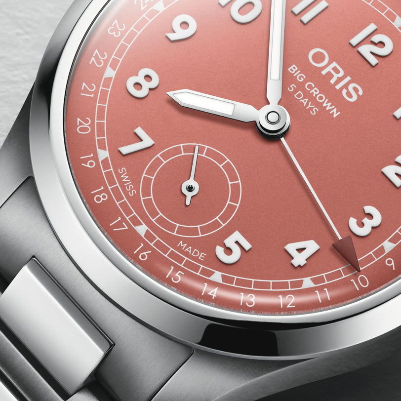 Close-up of an Oris Big Crown Pointer Date Calibre 403 wristwatch featuring a terracotta dial with Arabic numerals, date pointer, and a silver stainless steel case and bracelet.