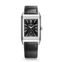 The Jaeger-LeCoultre Reverso Tribute Duoface Small Seconds is a rectangular steel wristwatch featuring a black dial with silver markers, a small seconds subdial, and a black leather strap. The brand name appears on the watch face.