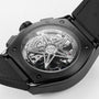 Close-up of the back of the Zenith Defy El Primero 21 wristwatch, showcasing its high-frequency chronograph movement and star-shaped rotor through a transparent case back, embodying Zenith’s bold urban design.