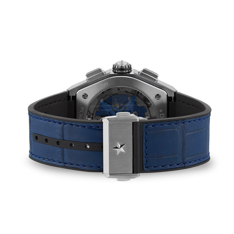 The Zenith Defy El Primero 21 is a luxury watch with a blue leather strap and a silver clasp accented by a star emblem.