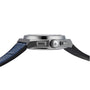 Side view of the Zenith Defy El Primero 21, a silver wristwatch featuring a blue strap and prominent crown and pushers.