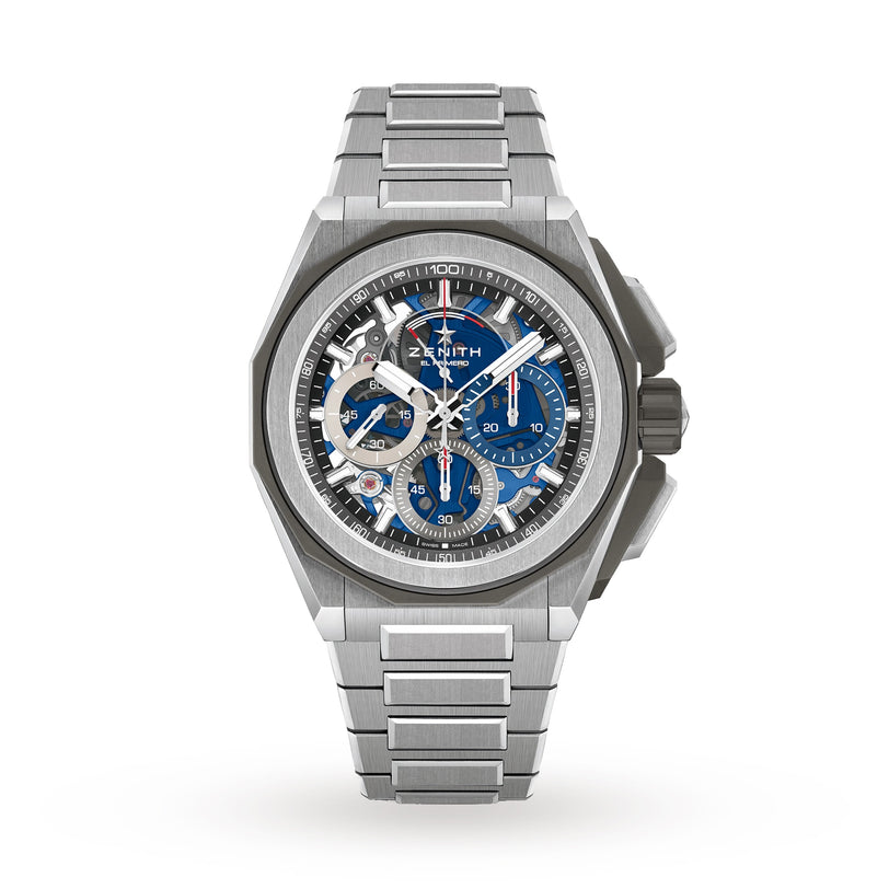 The Zenith Defy Extreme is a stainless steel wristwatch with a titanium case, blue chronograph subdials, skeleton accents, and a textured bezel, displayed against a plain white background.