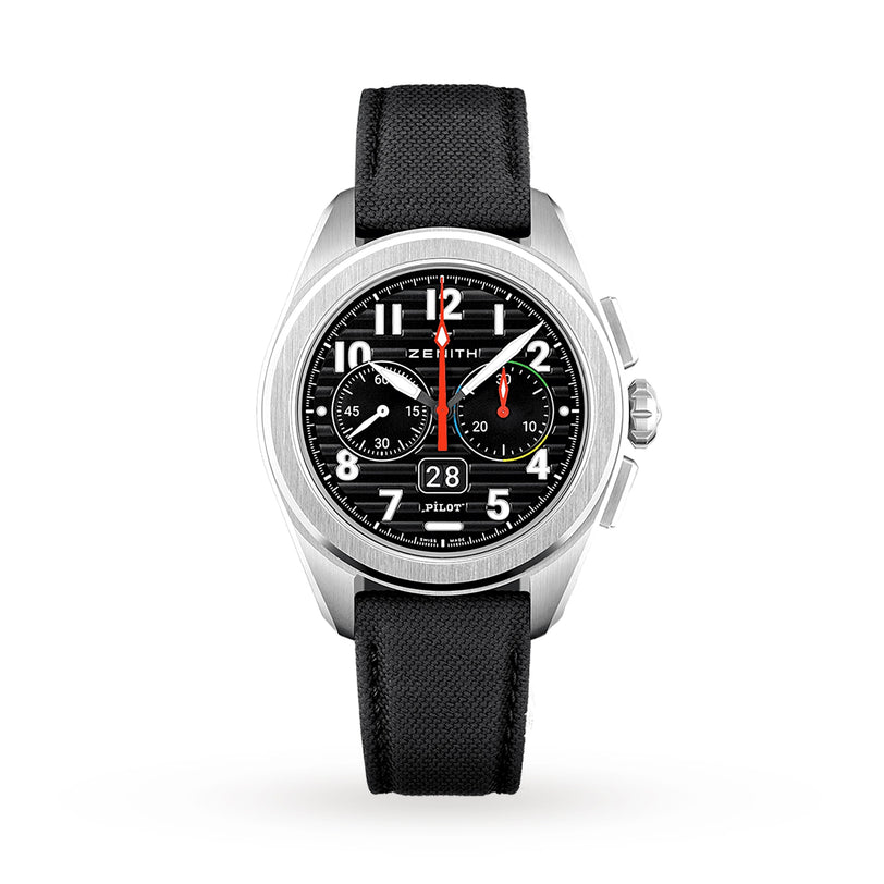 The Zenith Pilot Big Date Flyback is a silver pilot watch with a black ceramic case, black dial, white numerals, multicolored accents, two subdials, date window, and a black textured strap, shown on a white background.