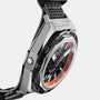 Close-up of the Zenith Defy Extreme Diver wristwatch featuring a black and orange dial, angular titanium case, automatic movement, and textured fabric strap set against a white background.