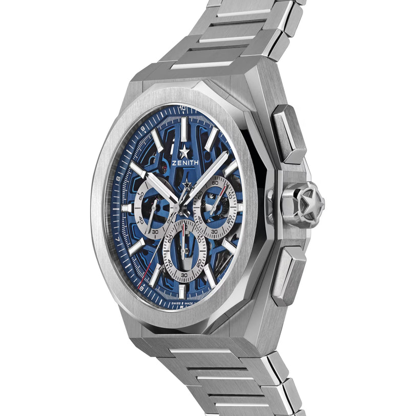 A Zenith Defy Skyline Skeleton - Blue wristwatch with a blue skeleton dial and metal link bracelet, shown at an angle.