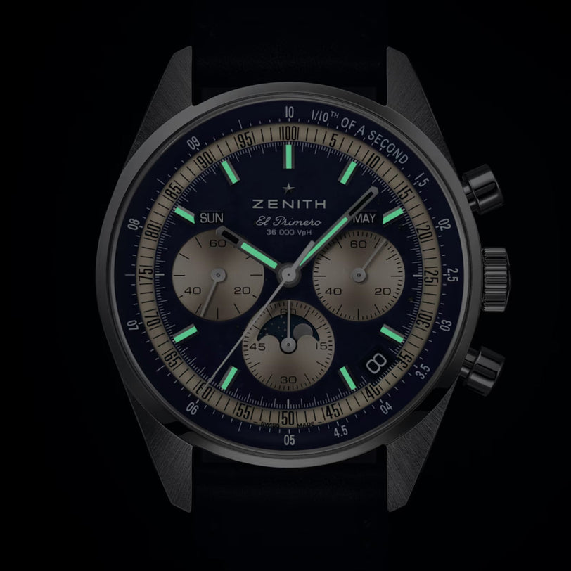 The Zenith Chronomaster Original Lapis Lazuli watch features three subdials, date indicators, and luminous hands on a black strap.