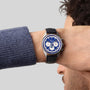 Someone wearing the Zenith Chronomaster Original Lapis Lazuli, a blue-silver chronograph watch with a black leather strap, on their wrist.
