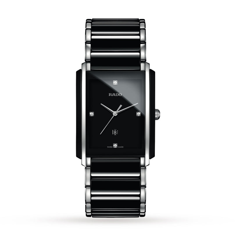 The Rado Integral Diamonds is a rectangular black watch featuring a silver and black metal band, minimalistic dial, high-tech ceramic accents, four diamond hour markers, and a date display at 6 o’clock.
