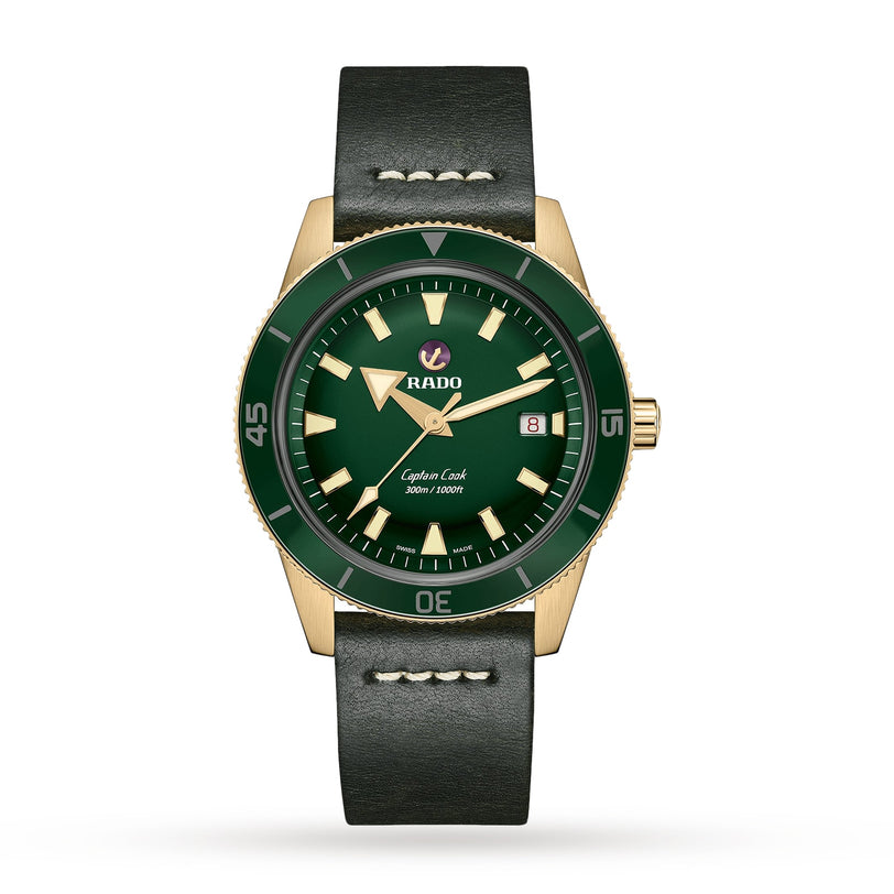 The Rado Captain Cook Automatic Bronze features a green dial with white hour markers, date display at 3 o’clock, bronze case, and black leather strap—a modern take on a vintage classic.