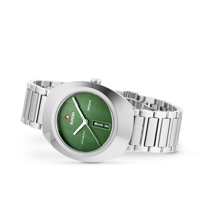 The Rado DiaStar Original is a silver-tone wristwatch featuring a green dial, sapphire crystal, automatic movement, day-date display, and stainless steel bracelet.