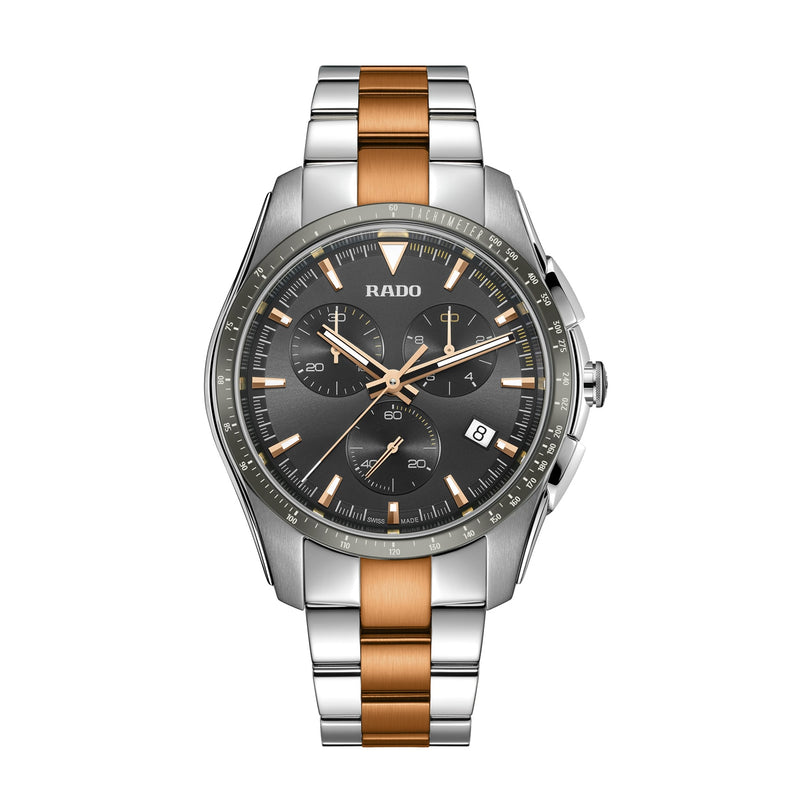 The Rado Hyperchrome Chronograph features a silver and rose gold metal band, black dial, high-tech ceramic accents, and a date display at 4 oclock.