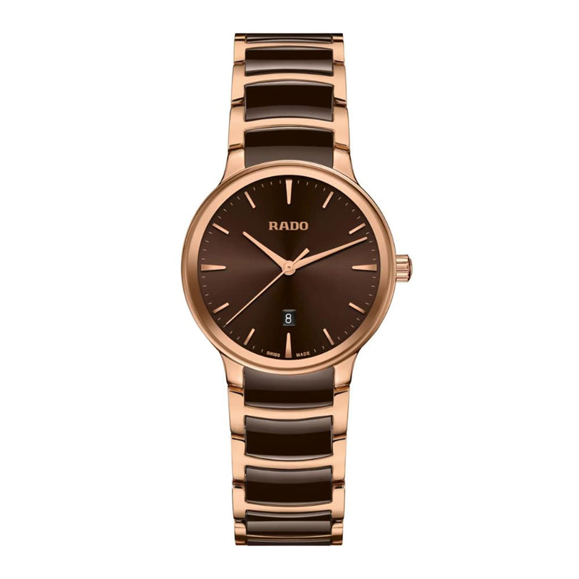The Rado Centrix is a luxury gold and brown watch with a round face, minimalist hour markers, a date window at 6 o’clock, and a sleek metal link band.