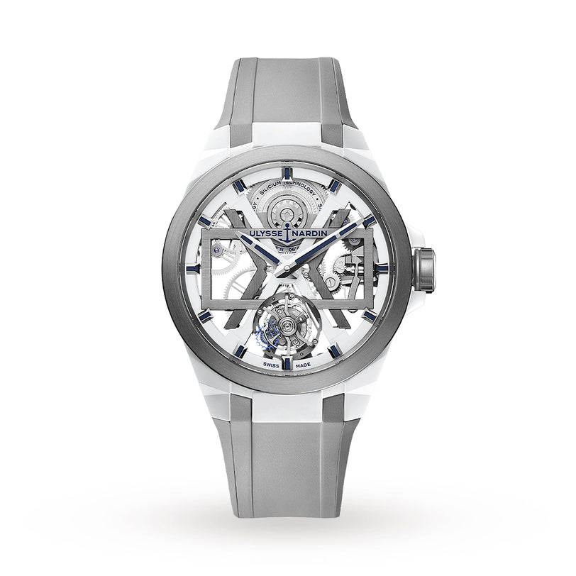 The Ulysse Nardin Blast Tourbillon features a transparent dial with visible gears, an automatic tourbillon, grey and white strap, Swiss Made label, and is displayed against a white background.