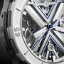 Close-up of the Ulysse Nardin Diver X Skeleton, showing its open-worked dial with visible gears, blue accents, bold hour and minute hands, all set in a sleek titanium case.
