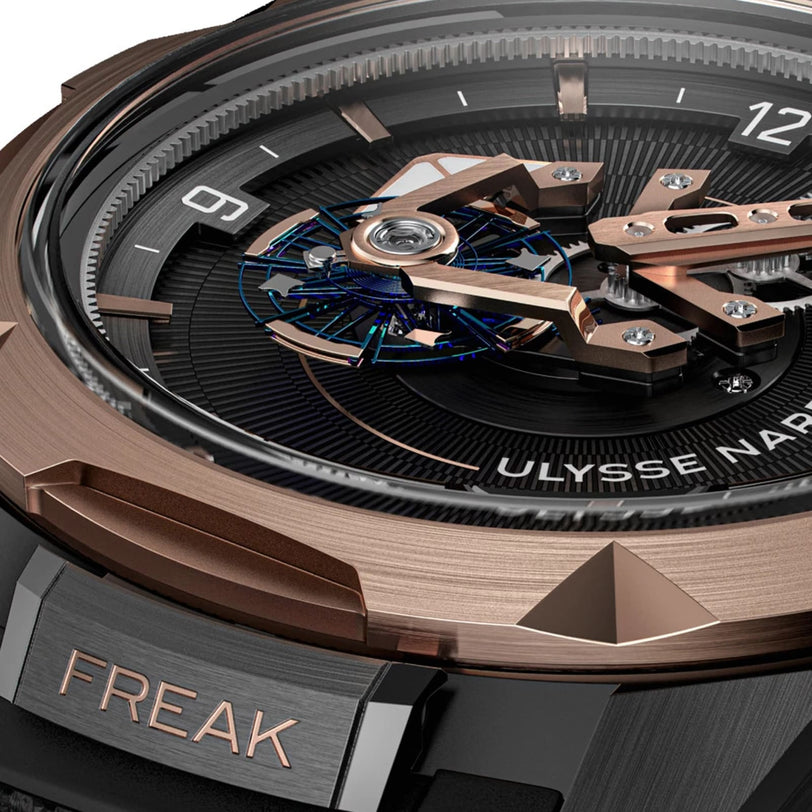 Close-up of the Ulysse Nardin Freak ONEs watch face, showcasing exposed mechanics, angular hands, FREAK engraved on the case, an orbital carrousel tourbillon, and a rotating disc.