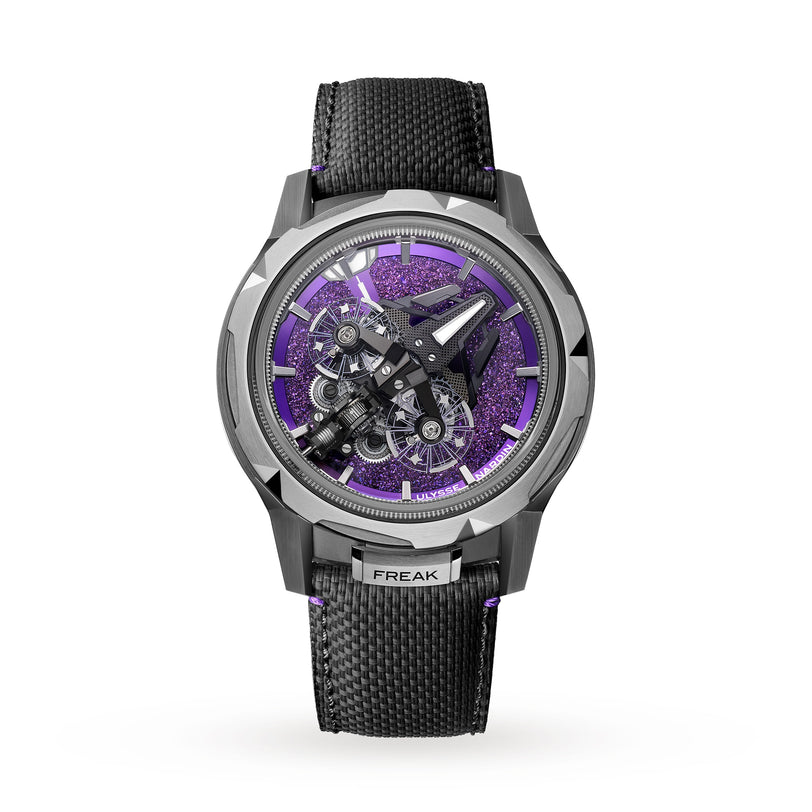 The Ulysse Nardin Freak S WOS Centenary Exclusive features a black strap, silver case, and exposed mechanical movement on a glittery purple dial, with FREAK engraved, showcasing the brand’s Haute Horlogerie expertise.