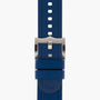 Blue silicone watch strap with rectangular holes and a silver metal buckle, ideal for the TUDOR Pelagos diving watch, shown vertically against a plain white background.